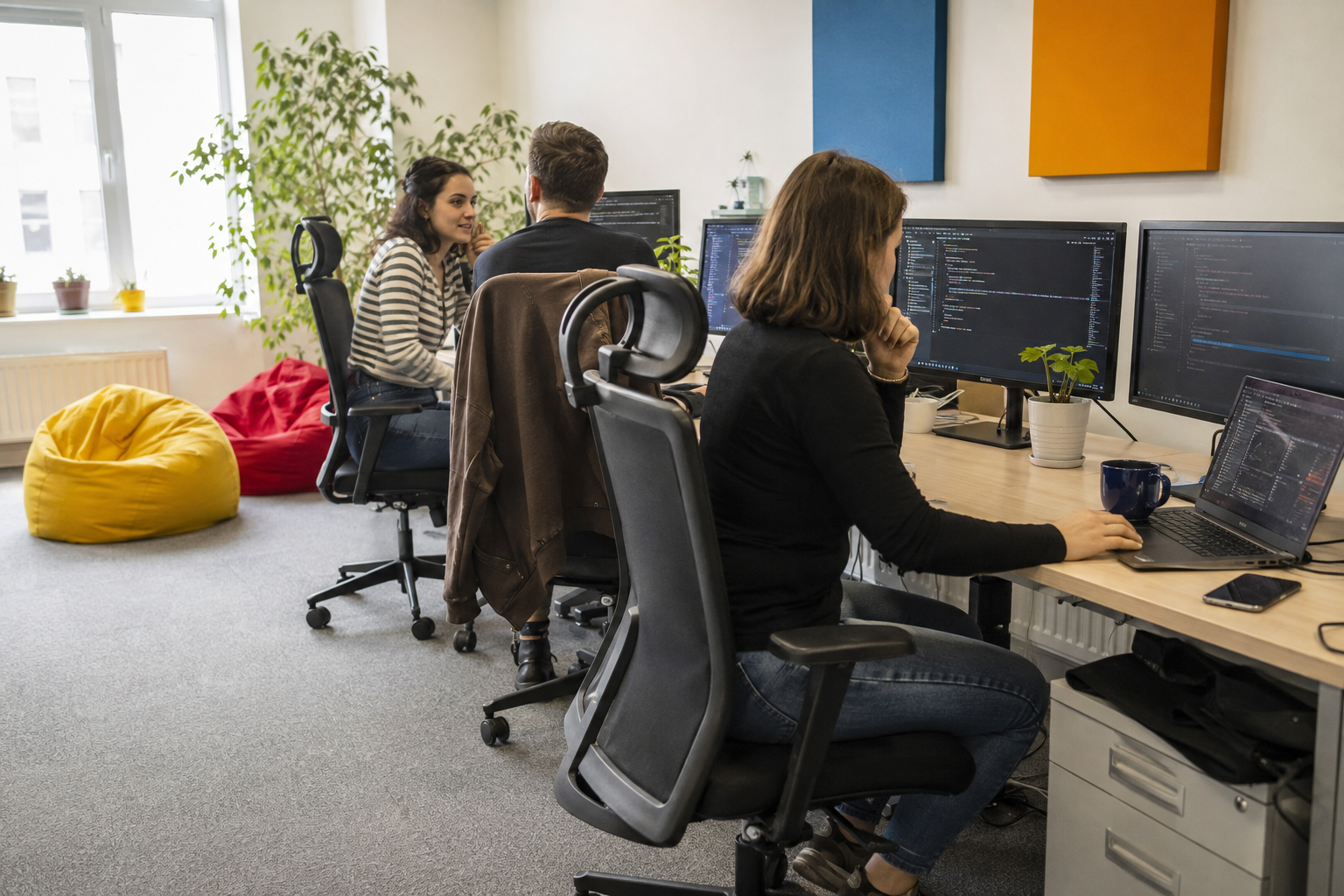 People coding and collaborating at their workstations